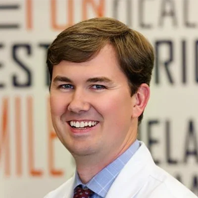 a photo showing Orthodontist Matthew J. Olmsted smiling warmly at the viewer